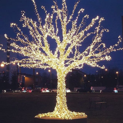 Picture of an artificial Tree wrapped in mini LED lights